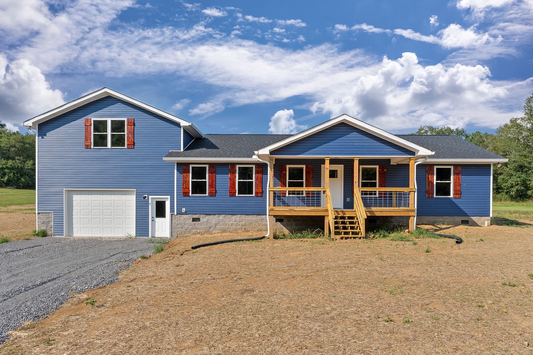 a front view of a house with yard and porch