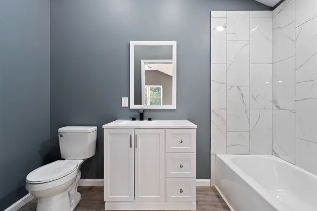 a bathroom with a sink a toilet and bathtub
