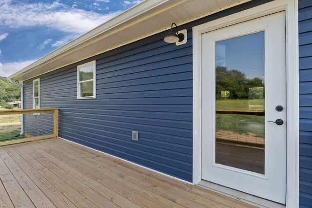 a front view of a house with a yard covered in snow