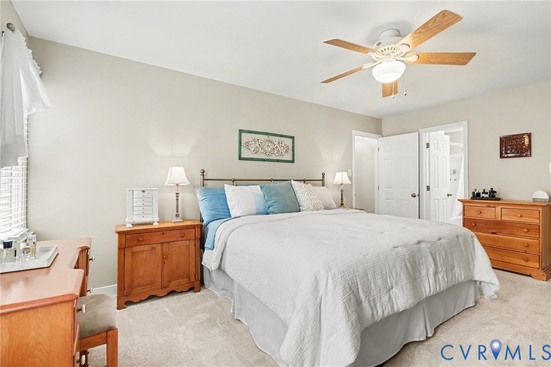 548 Glenmeadow Road Midlothian, VA 23114 - Photo 14 of 31 a bedroom with a bed and a chandelier
