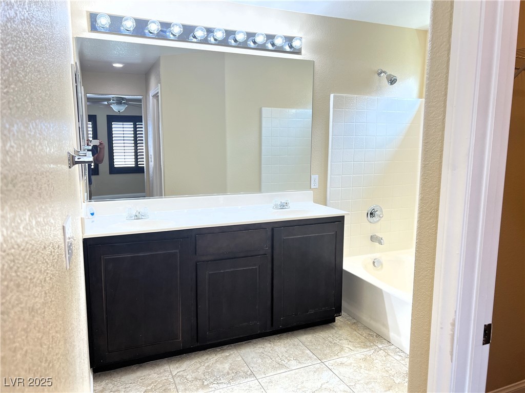 9535 Leaping Lizard Street Las Vegas, NV 89178 - Photo 9 of 37 Bathroom with shower / washtub combination, tile flooring and double vanity