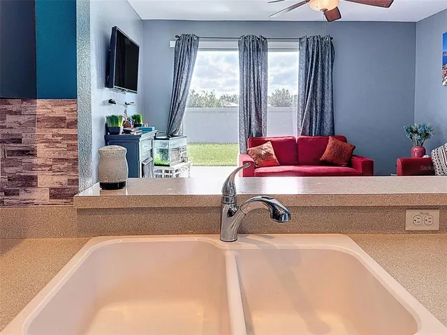 a living room with furniture ceiling fan and a rug