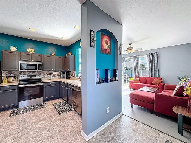 a large kitchen with a table and chairs
