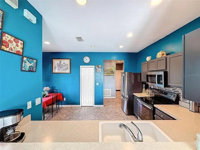 a view of a hallway and a livingroom with furniture