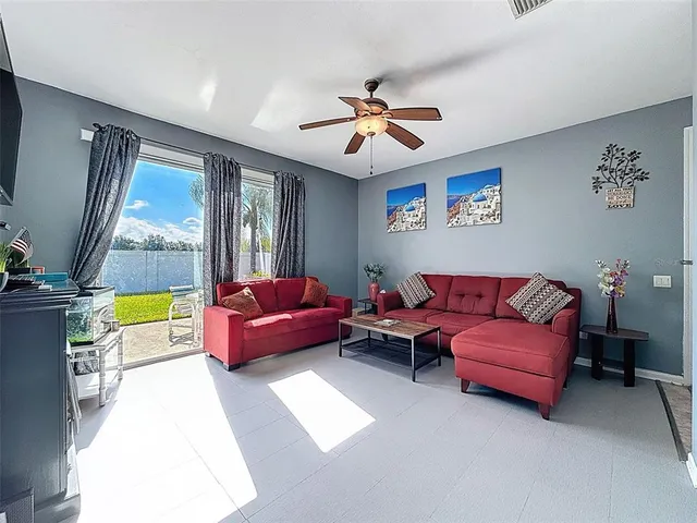 a bedroom with a bed window and a flat screen tv