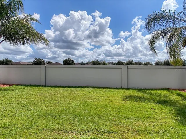 a view of a backyard with swimming pool