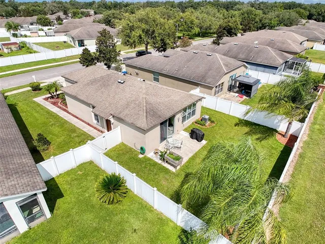 an aerial view of a house with garden space and ocean view
