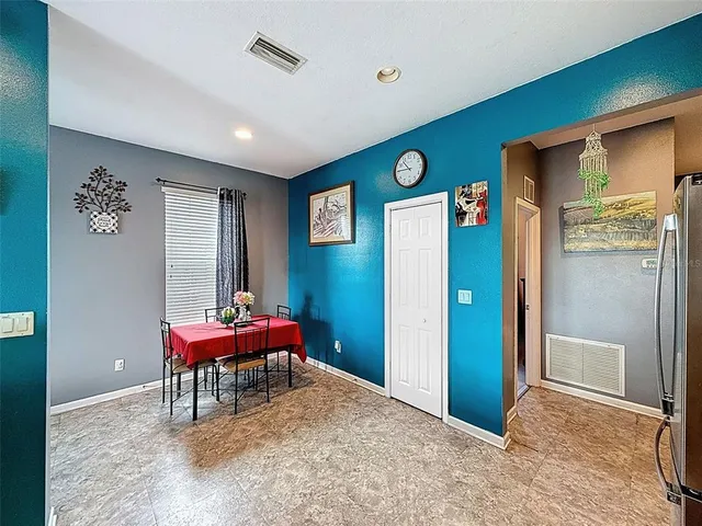 a kitchen with a refrigerator and a stove top oven