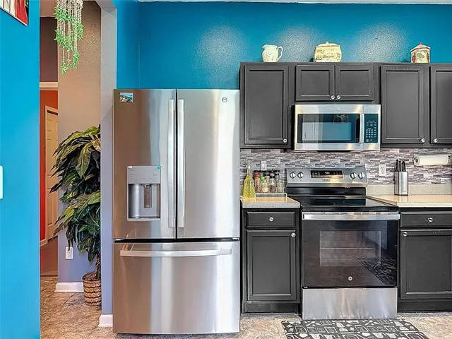 a kitchen with a sink stove and refrigerator
