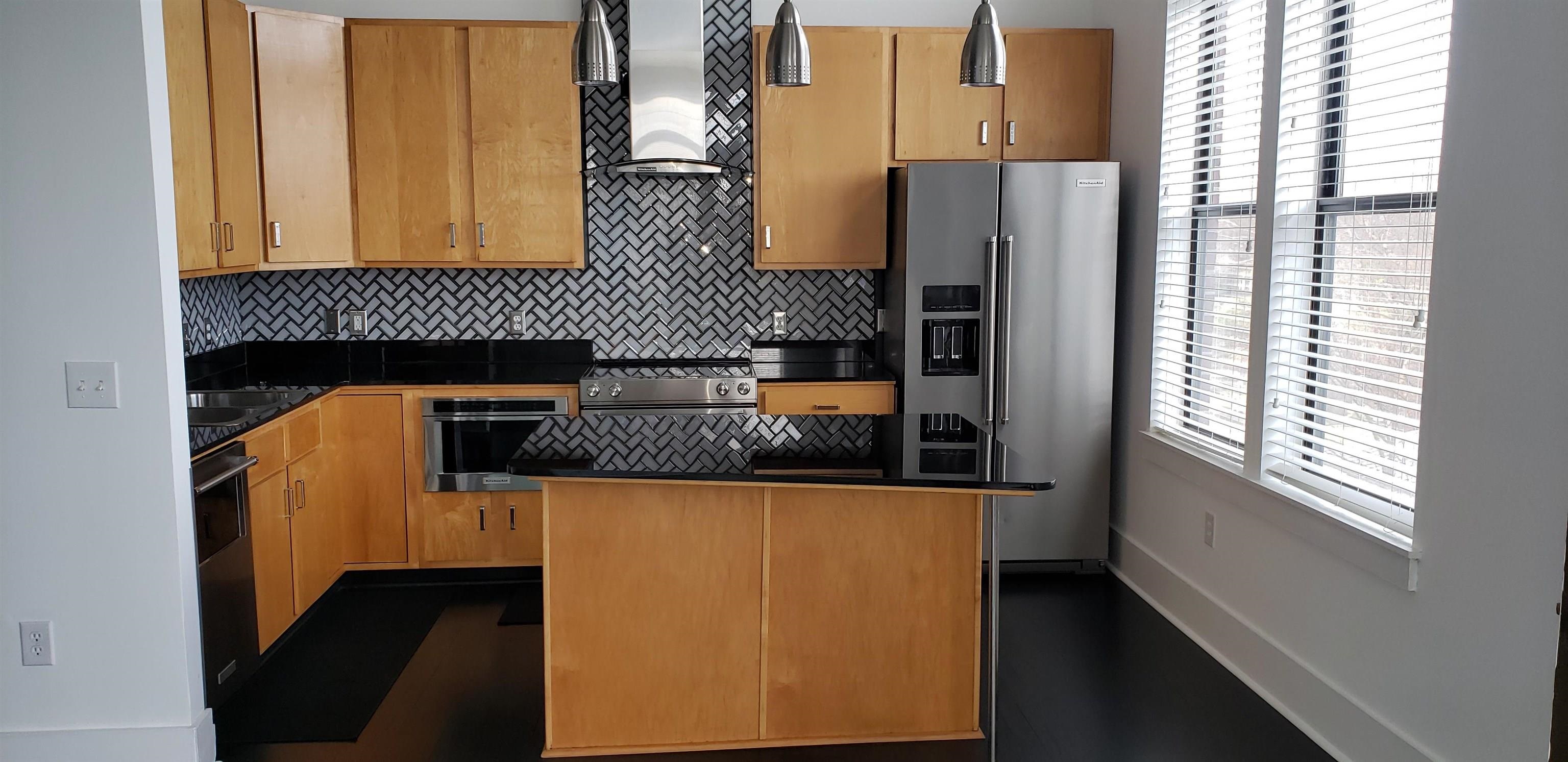 700 Harbor Bend Road, Unit 202 Memphis, TN 38103 - Photo 12 of 18 a kitchen with stainless steel appliances a refrigerator and a stove