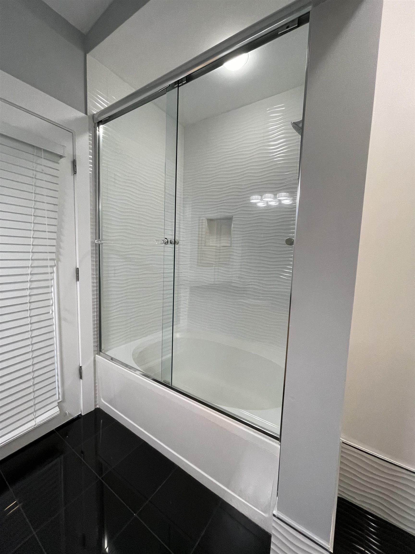 700 Harbor Bend Road, Unit 202 Memphis, TN 38103 - Photo 15 of 18 a bathroom with a bathtub and a shower