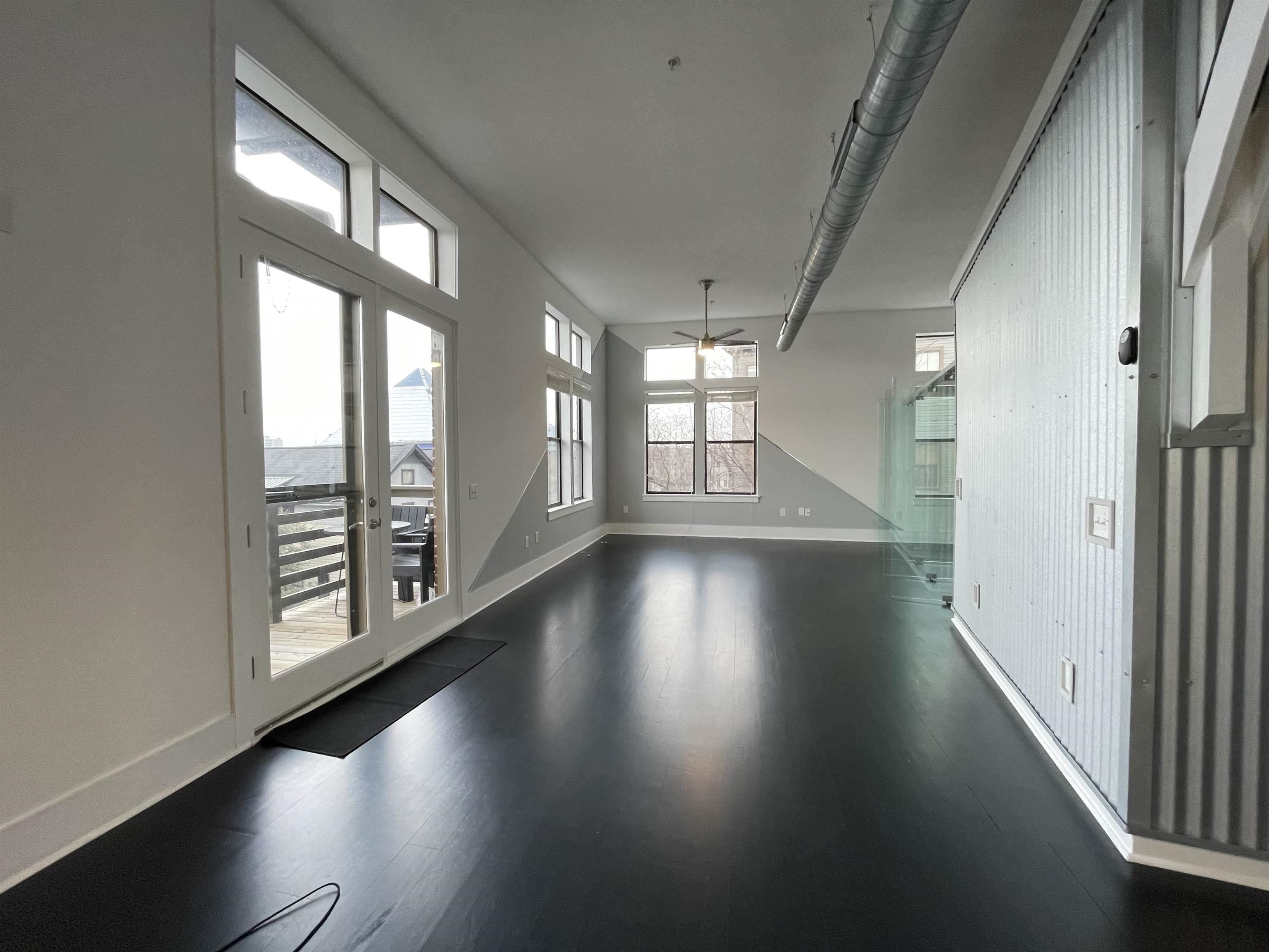 700 Harbor Bend Road, Unit 202 Memphis, TN 38103 - Photo 3 of 18 an empty room with wooden floor and windows