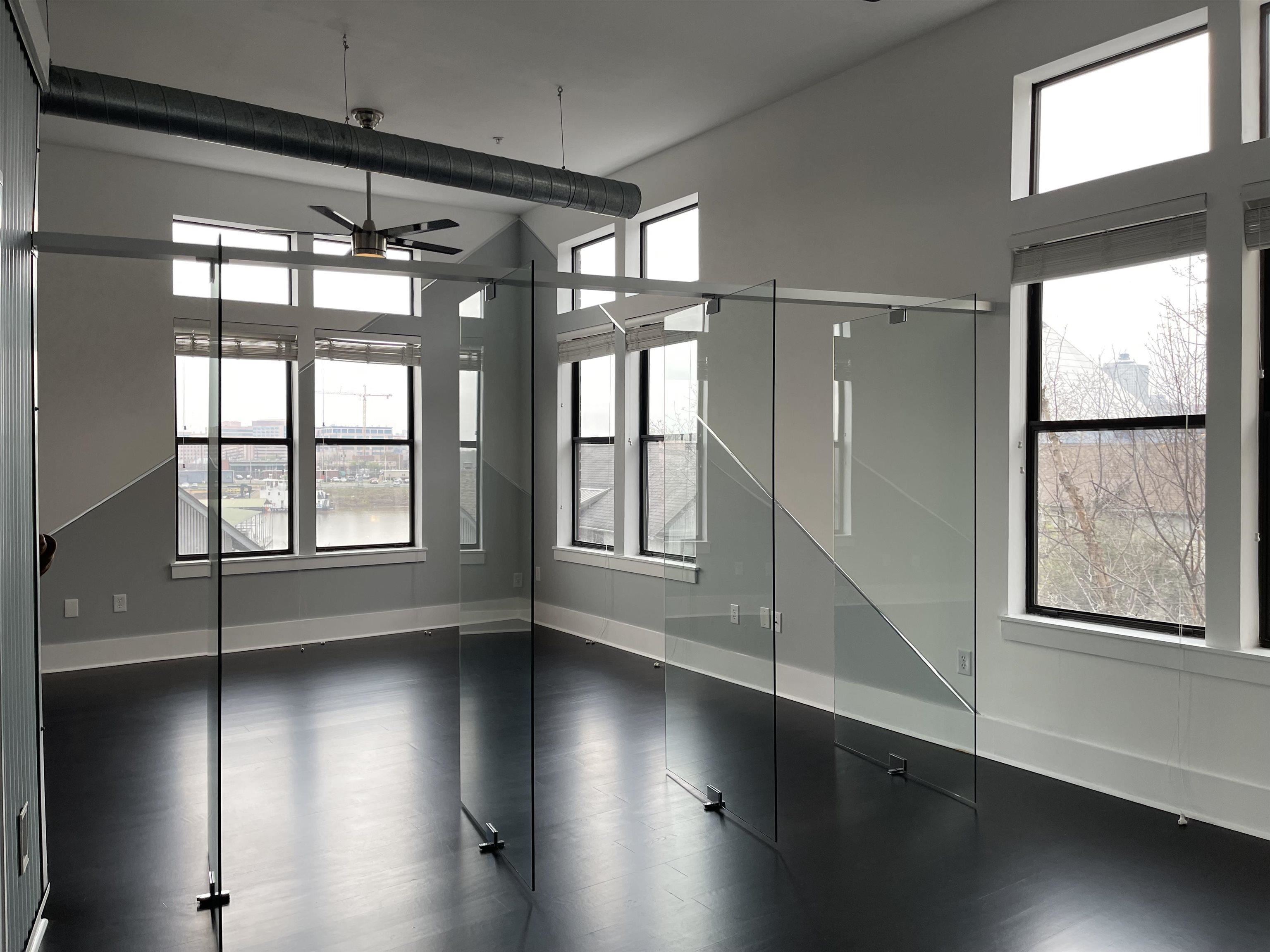 700 Harbor Bend Road, Unit 202 Memphis, TN 38103 - Photo 5 of 18 a view of an empty room with wooden floor and a window