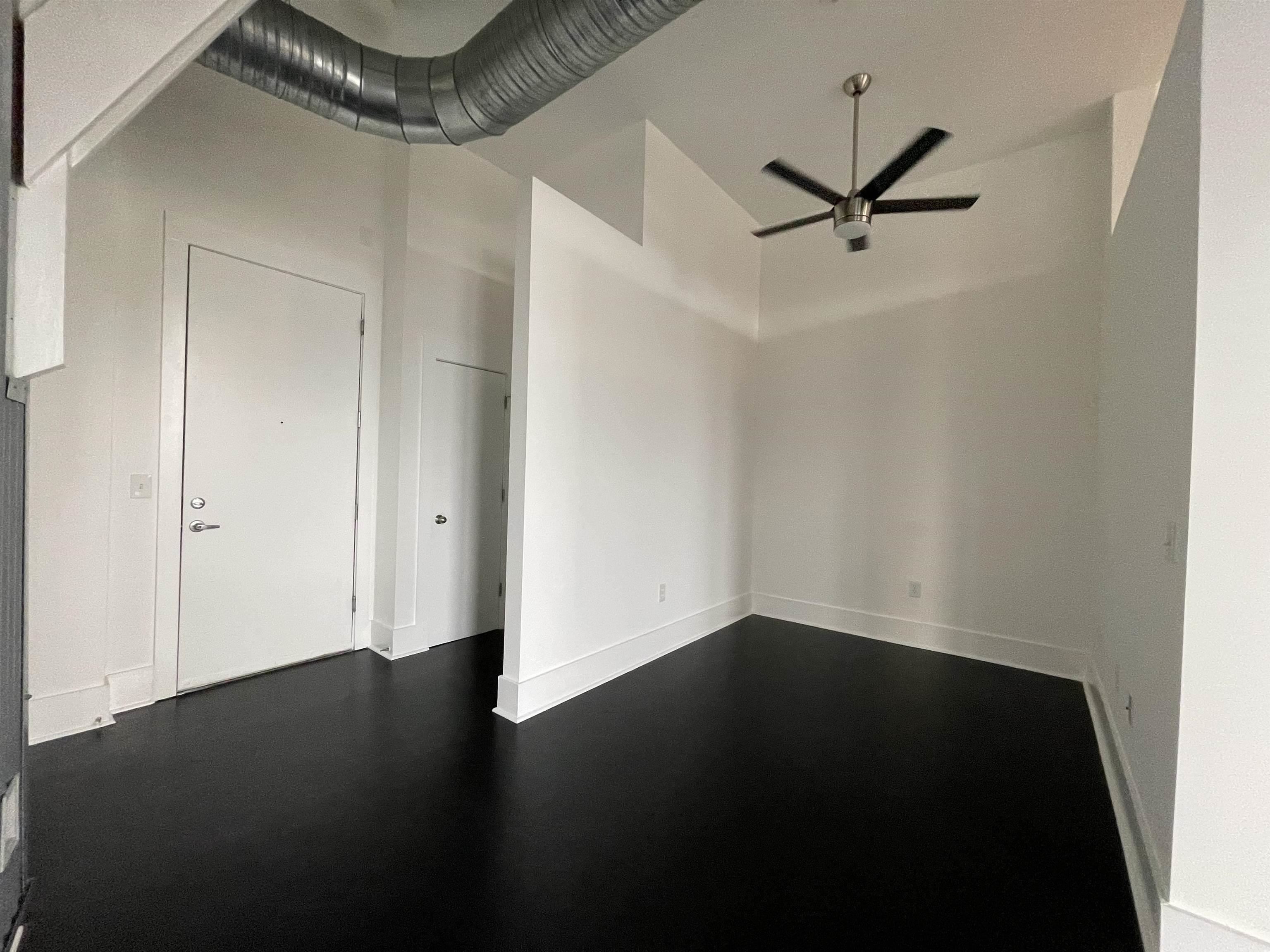 700 Harbor Bend Road, Unit 202 Memphis, TN 38103 - Photo 6 of 18 an empty room with wooden floor closet and windows