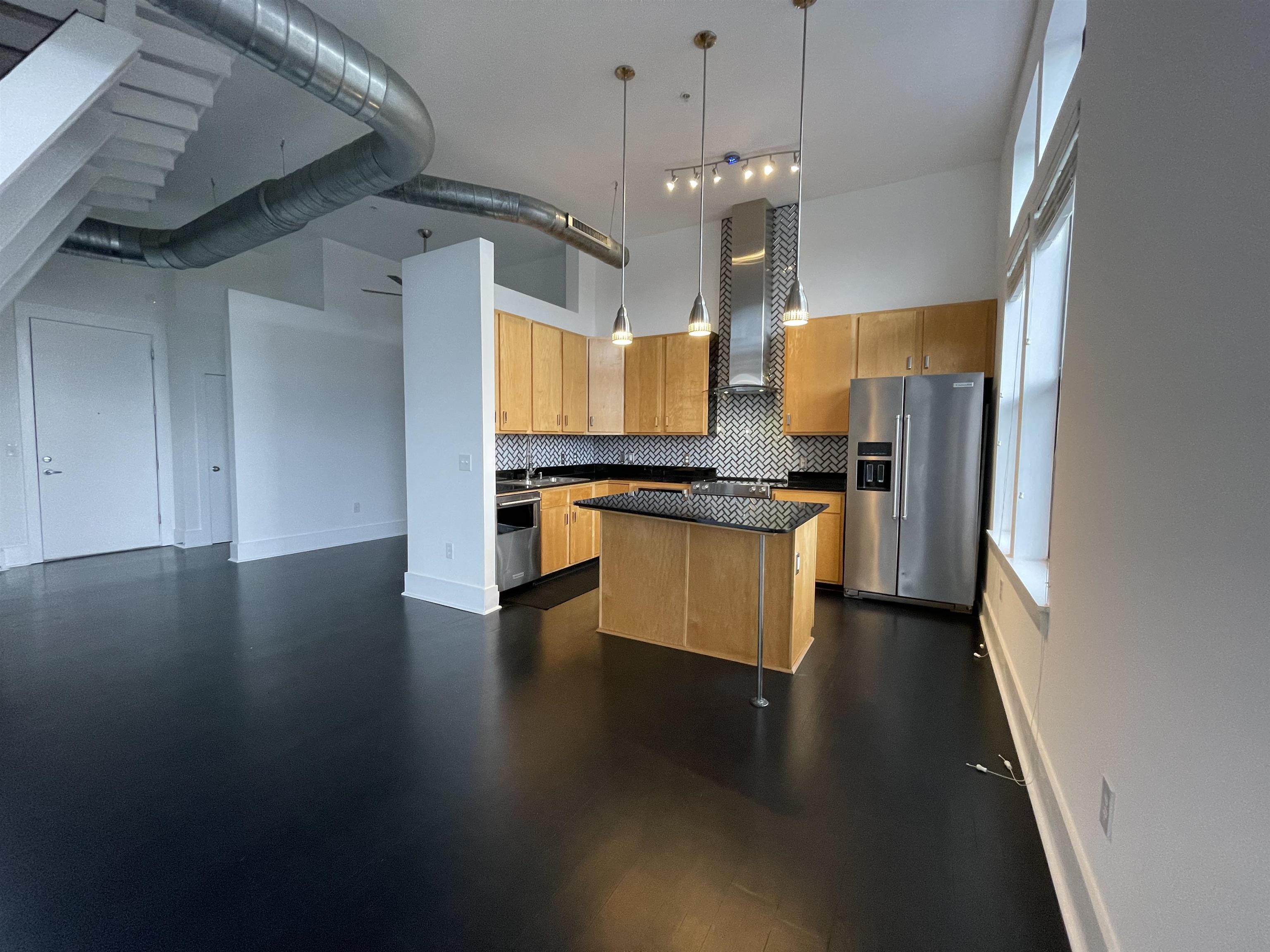 700 Harbor Bend Road, Unit 202 Memphis, TN 38103 - Photo 7 of 18 a kitchen with stainless steel appliances a stove refrigerator and cabinets