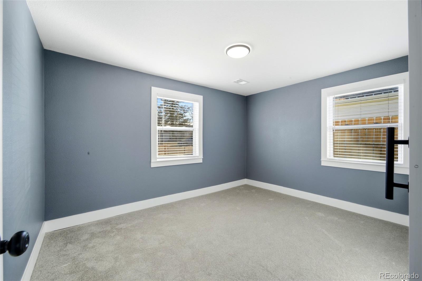4933 Steele Street Denver, CO 80216 - Photo 14 of 31 an empty room with windows