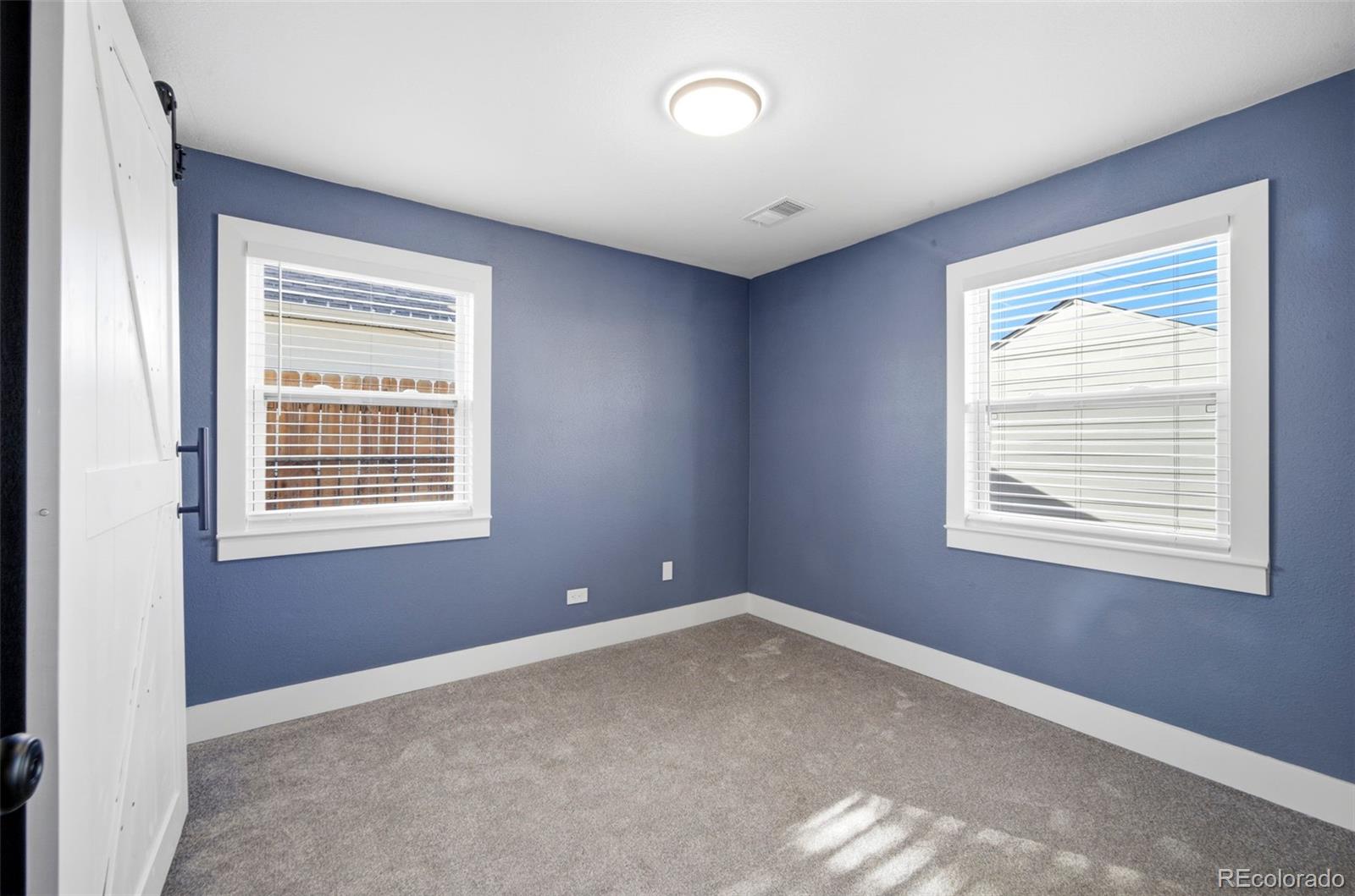 4933 Steele Street Denver, CO 80216 - Photo 15 of 31 an empty room with a window