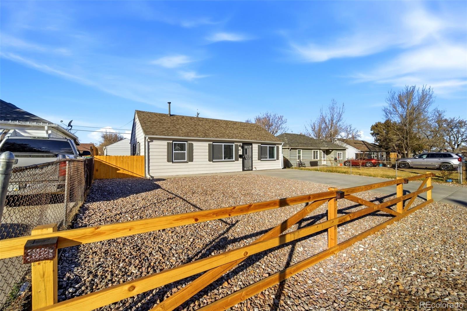 4933 Steele Street Denver, CO 80216 - Photo 3 of 31 a house with trees in front of it