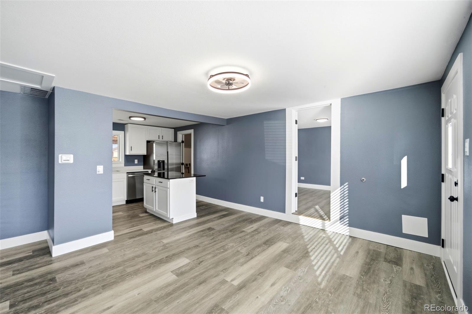 4933 Steele Street Denver, CO 80216 - Photo 7 of 31 a view of a kitchen with a sink and cabinets