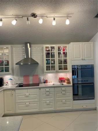 a kitchen with granite countertop a stove and cabinets