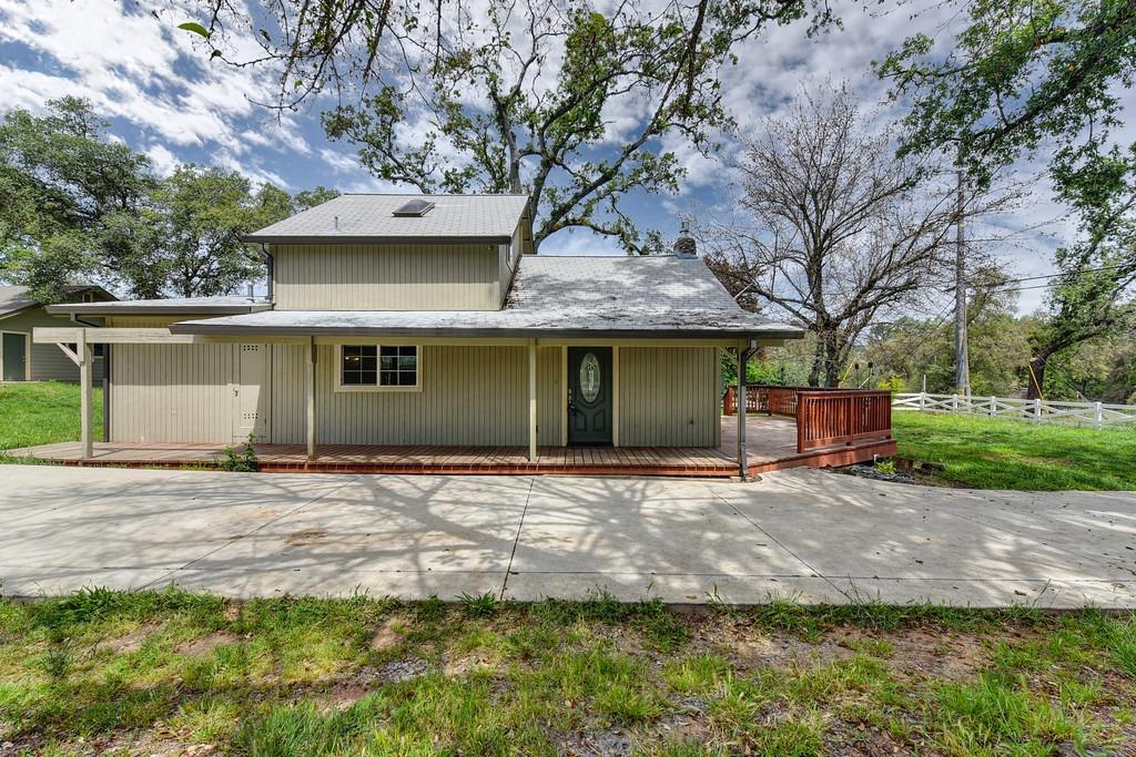 4524 Salmon Falls Road Pilot Hill, CA 95664 - Photo 15 of 47 a front view of a house with a garden and trees