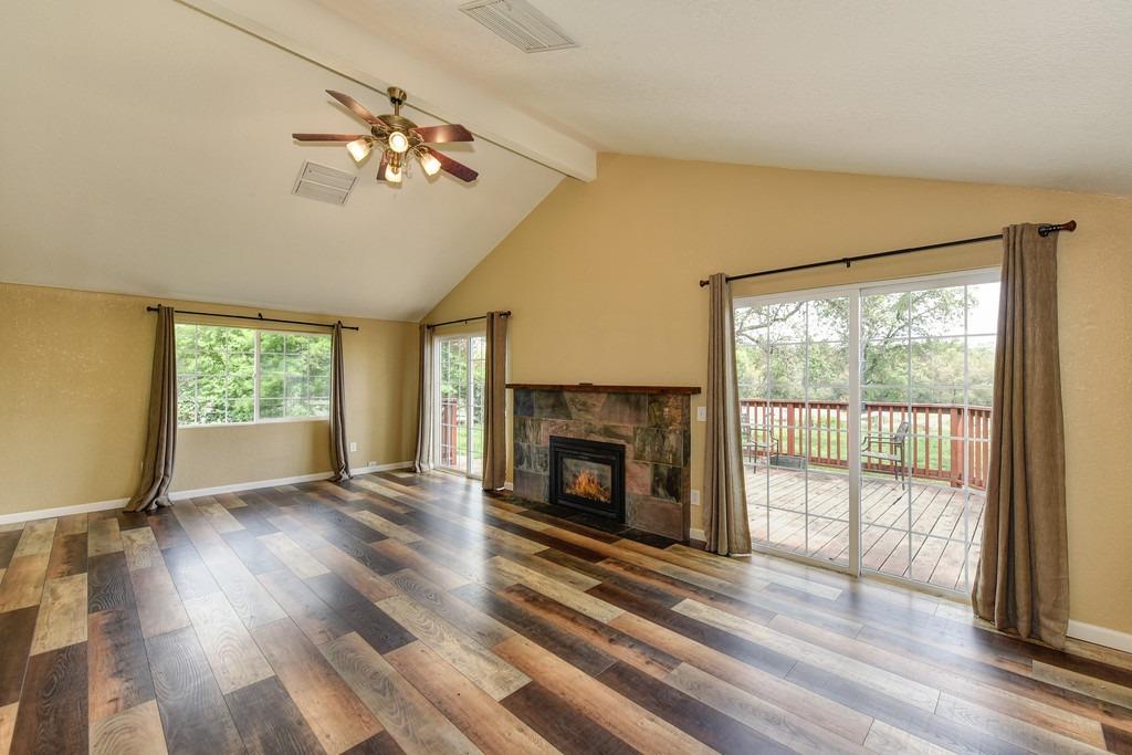 4524 Salmon Falls Road Pilot Hill, CA 95664 - Photo 20 of 47 a view of an empty room with wooden floor fireplace and a window