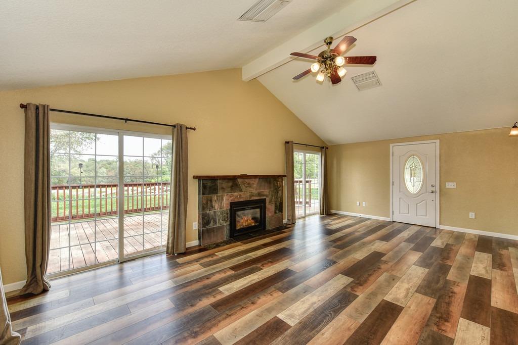 4524 Salmon Falls Road Pilot Hill, CA 95664 - Photo 21 of 47 a view of an empty room with a fireplace and a window
