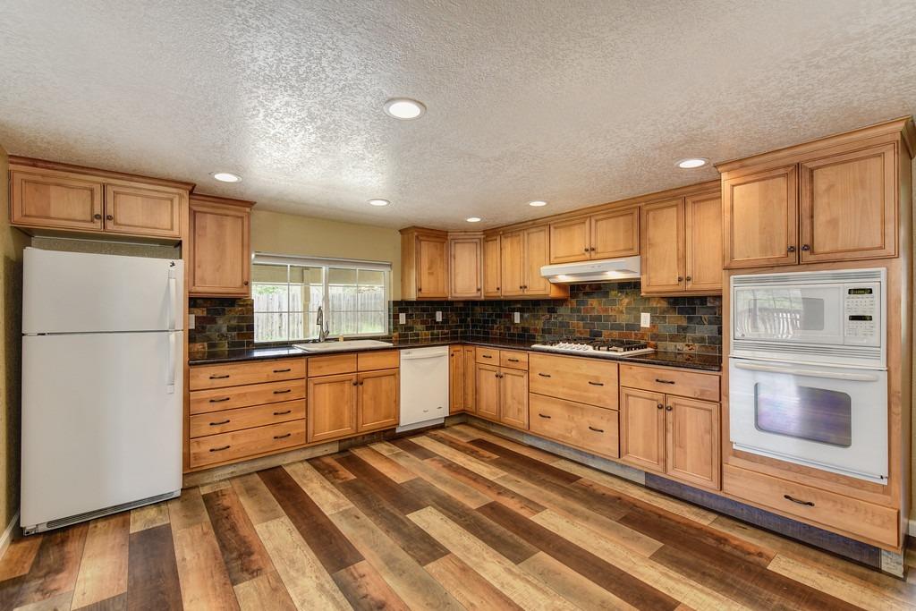 4524 Salmon Falls Road Pilot Hill, CA 95664 - Photo 23 of 47 a kitchen with granite countertop stainless steel appliances and refrigerator