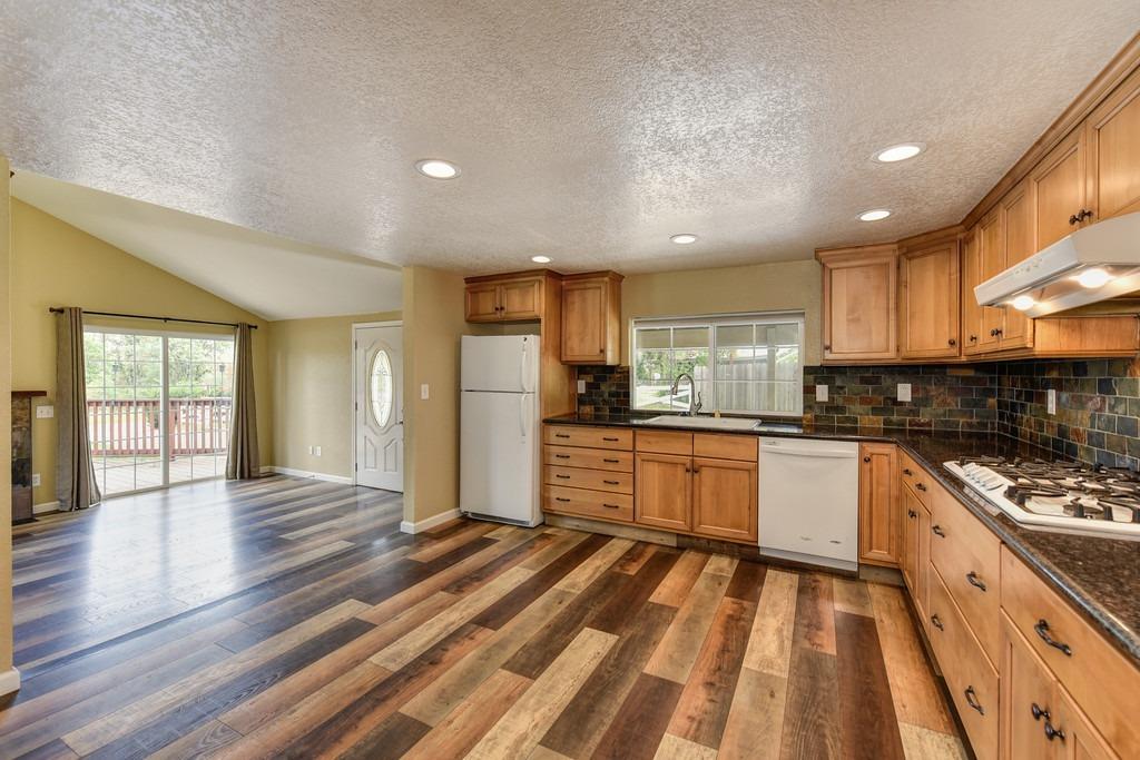 4524 Salmon Falls Road Pilot Hill, CA 95664 - Photo 24 of 47 a kitchen with stainless steel appliances granite countertop a refrigerator and a stove top oven