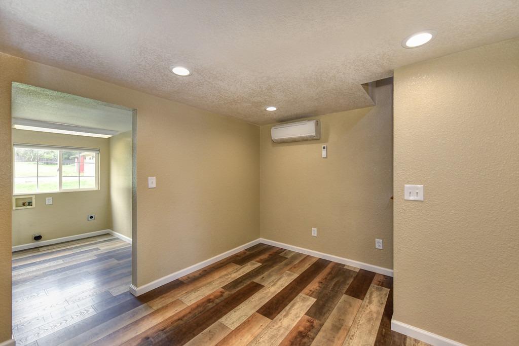 4524 Salmon Falls Road Pilot Hill, CA 95664 - Photo 27 of 47 an empty room with wooden floor and windows
