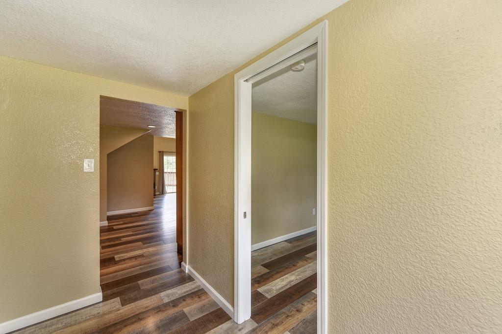 4524 Salmon Falls Road Pilot Hill, CA 95664 - Photo 30 of 47 a view of a hallway with wooden floor and staircase