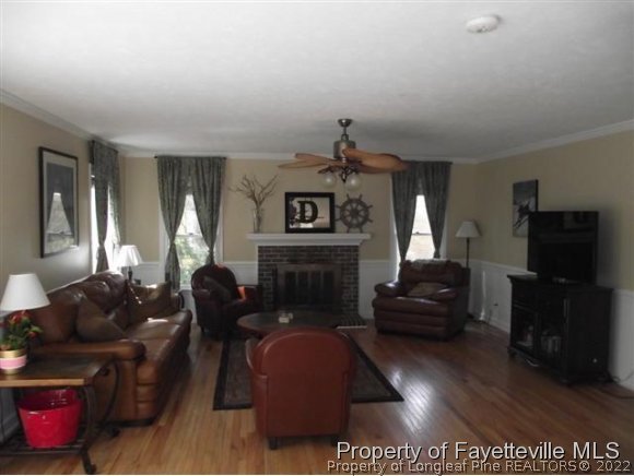 7796 Trappers Road Fayetteville, NC 28311 - Photo 2 of 24 a living room with furniture a flat screen tv and a fireplace