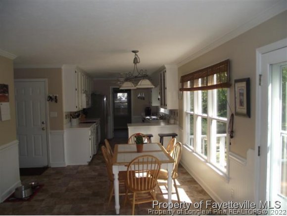 7796 Trappers Road Fayetteville, NC 28311 - Photo 4 of 24 a view of a dining room with furniture window and wooden floor