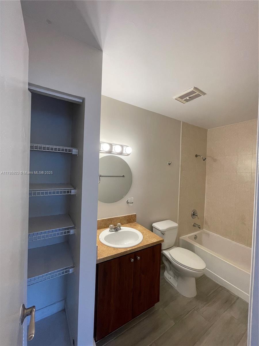 West End Miami, FL 33193 - Photo 12 of 12 a bathroom with a double vanity sink toilet mirror and bathtub