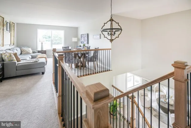 a spacious bedroom with a bed and chair