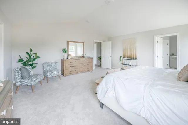 a spacious bedroom with a bed and a dresser in it