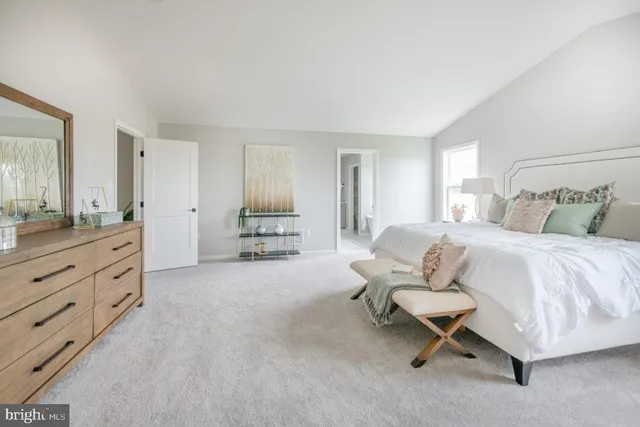 a spacious bathroom with a double vanity sink mirror and bathtub