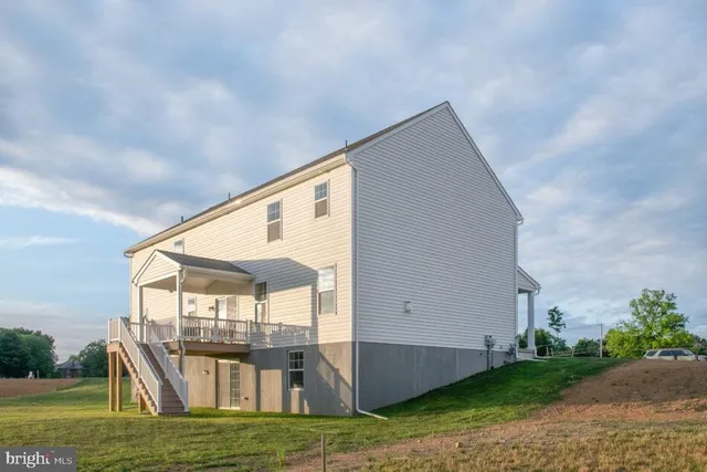 a view of a balcony with chair and wooden floor