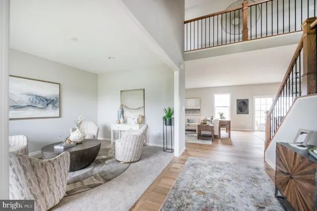 a living room with furniture fireplace and a window