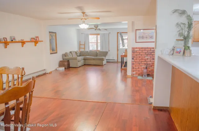 an entryway and livingroom with furniture