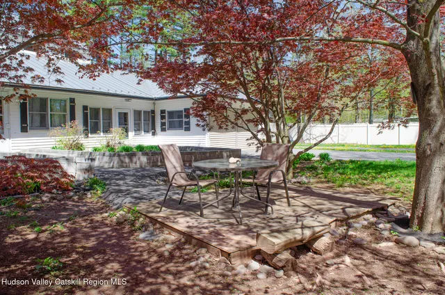 a view of a house with backyard sitting area and garden