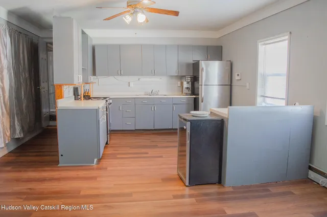 a kitchen with a refrigerator sink and wooden cabinets