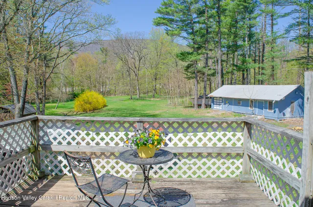 a view of a chair and table in the front yard