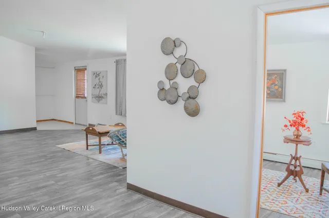 a view of a livingroom with furniture and wooden floor