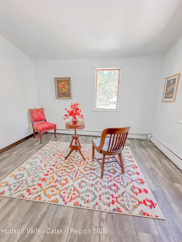 a living room with furniture rug and wooden floor