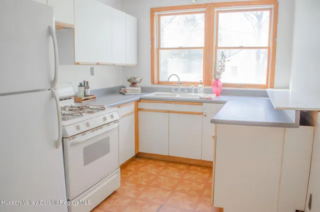 a kitchen with stainless steel appliances a stove sink and window