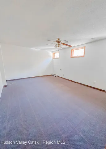 an empty room with a empty space and windows