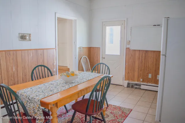 a kitchen with granite countertop a table and chairs