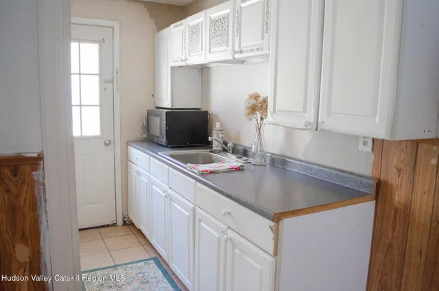 a kitchen with stainless steel appliances granite countertop a sink stove and microwave