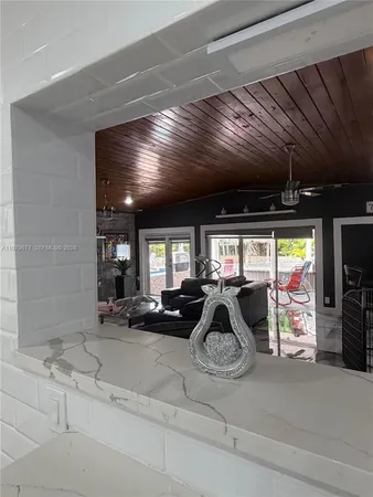 a view of a room that has a window and a ceiling fan